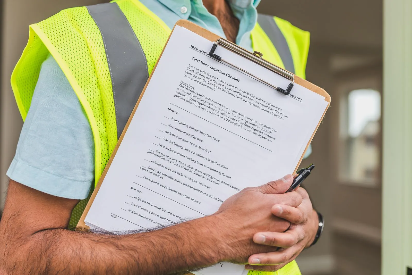 An inspector holding a clipboard with a home inspection checklist