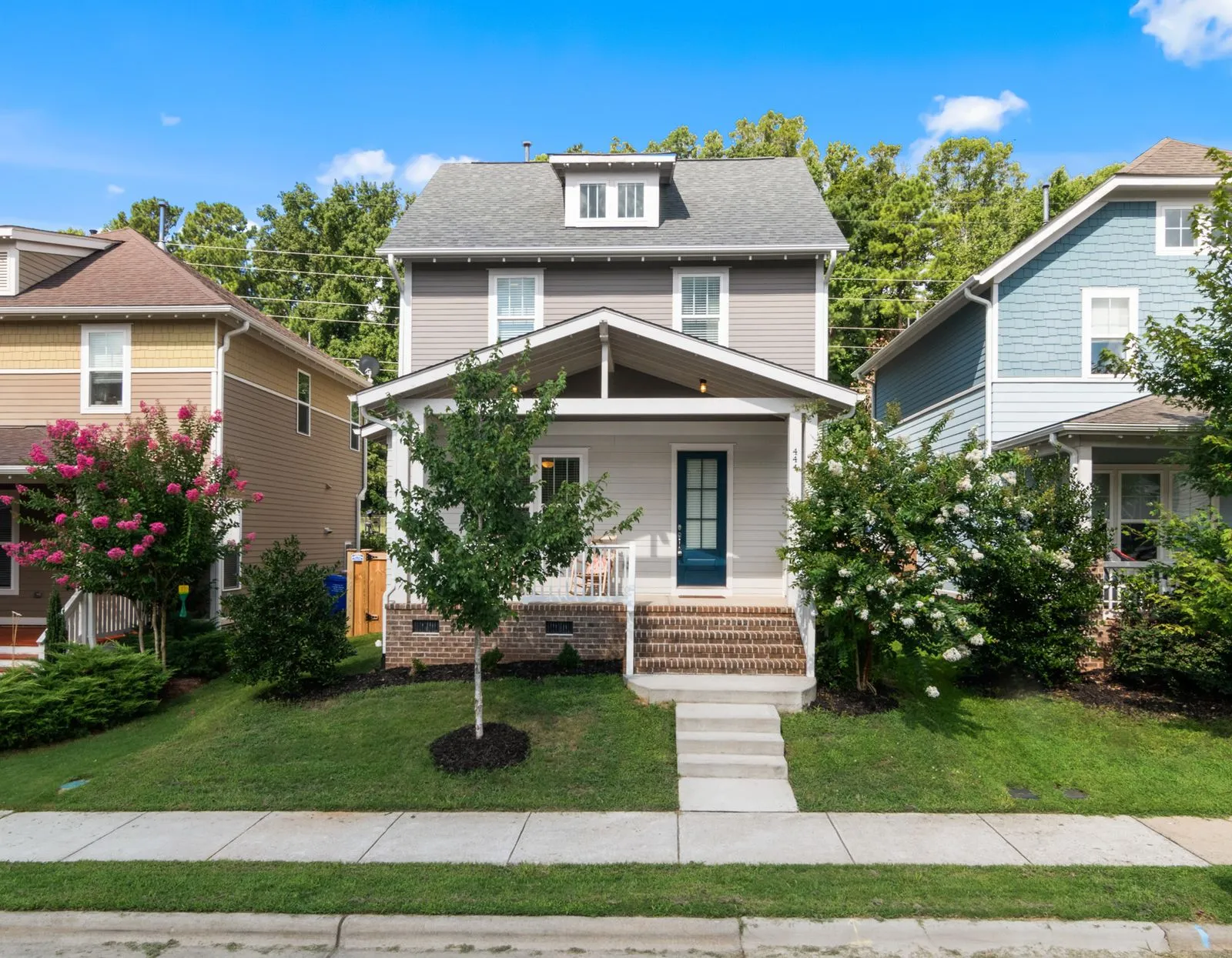 The front of a suburban house with lap siding and a covered porch